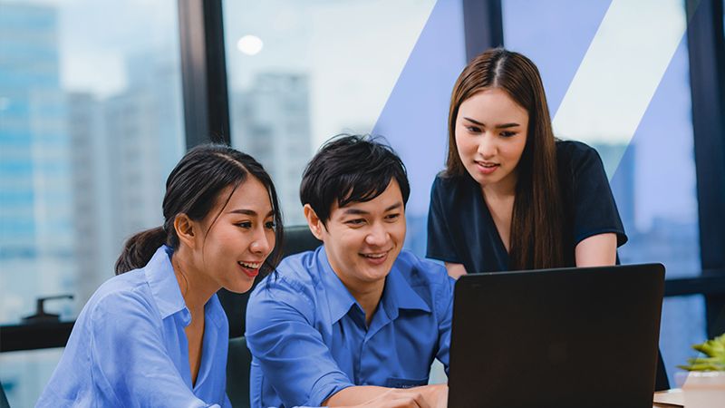 Three professionals helping a client optimize his ecommerce operations