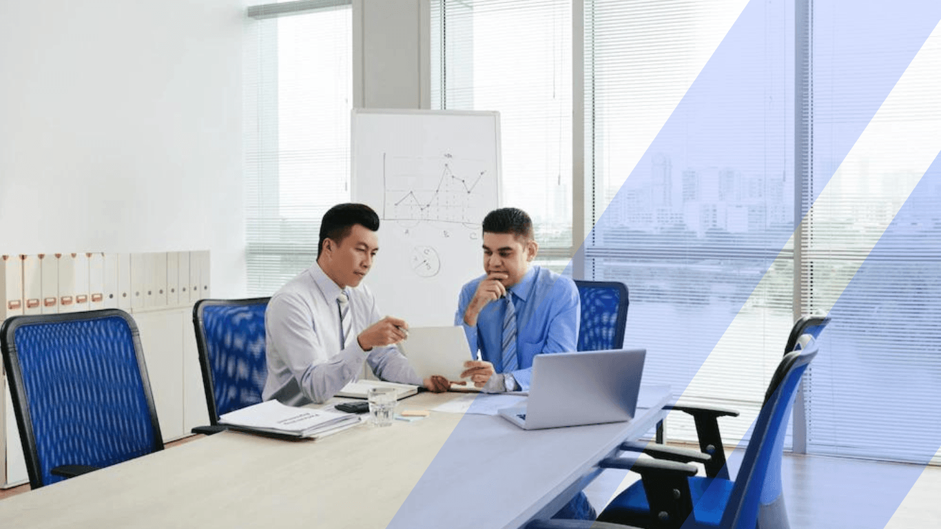 Two male professionals discussing in a room