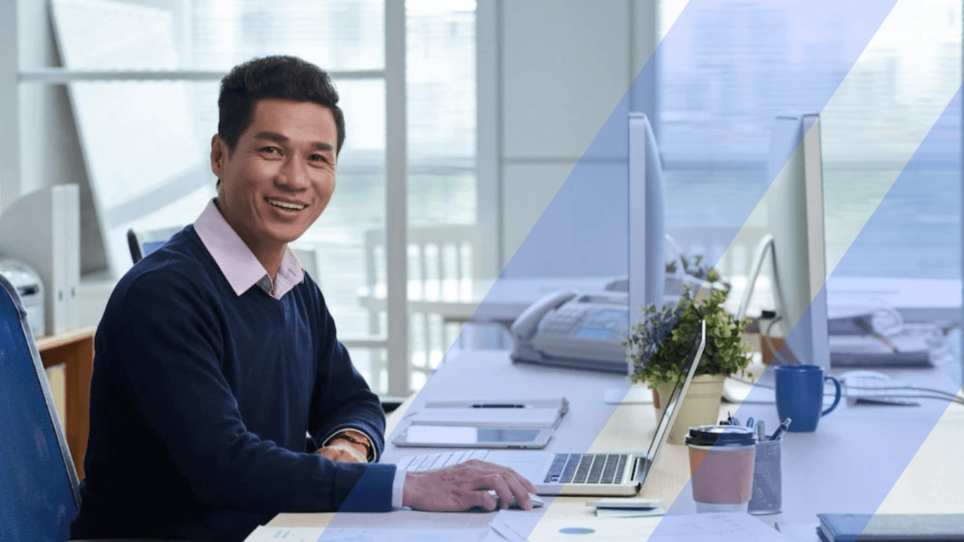Asian man sitting in front of his laptop