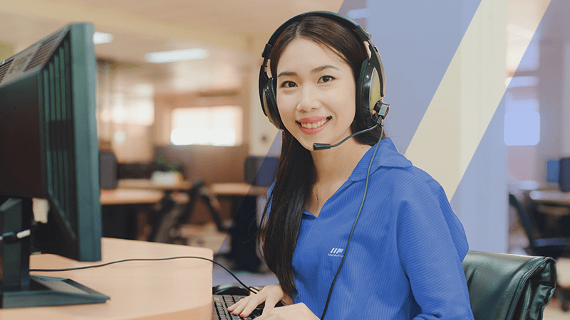 A customer support services pro working in front of a desktop computer