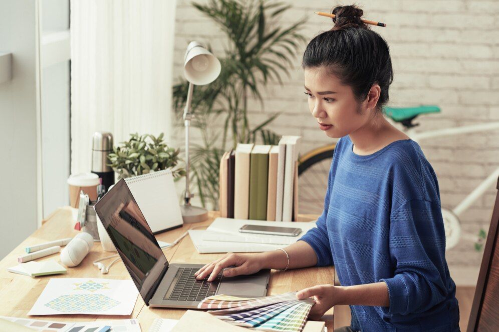 A graphic designer researching color palettes on her laptop