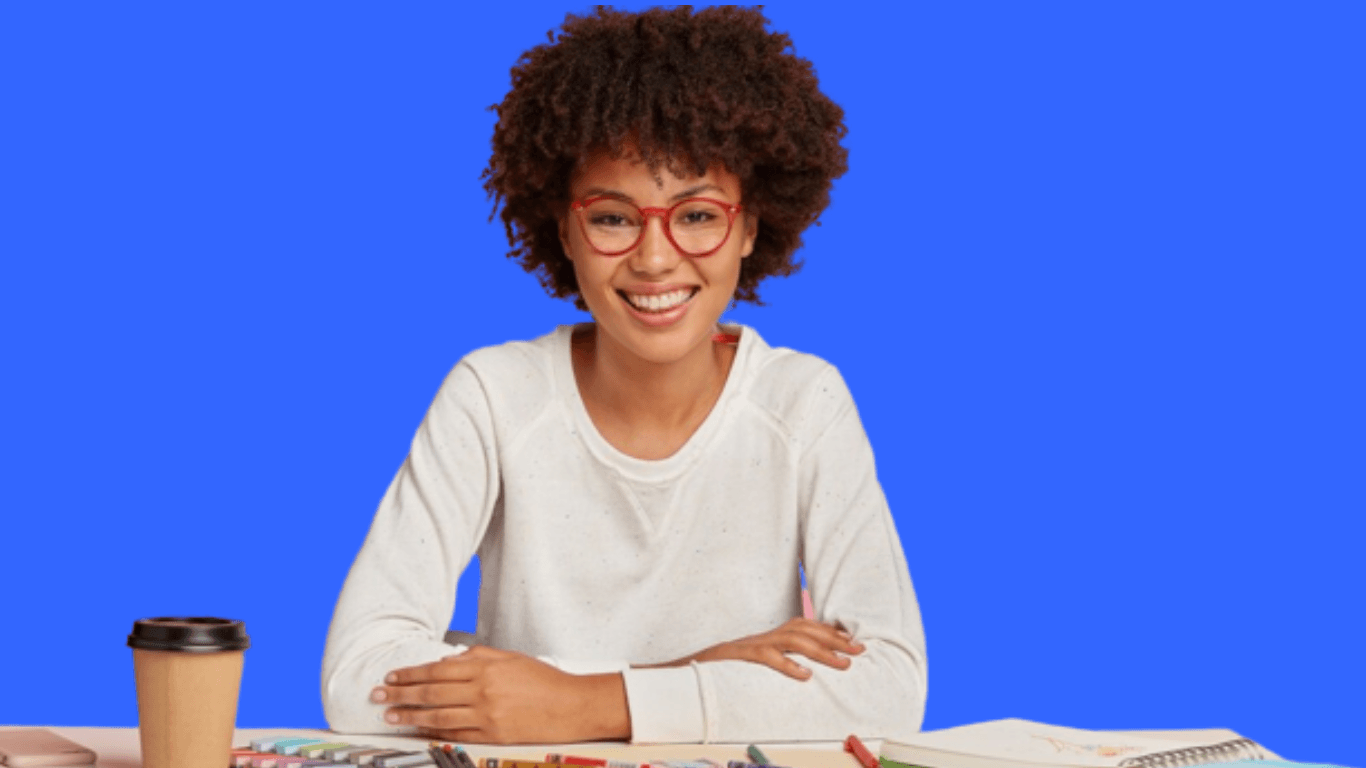 A happy graphic designer in front of her working table
