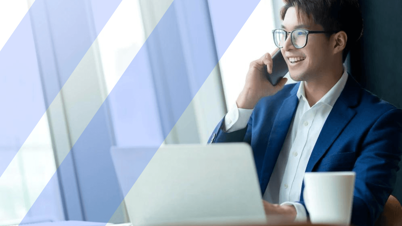 A young asian man talking to someone over the phone