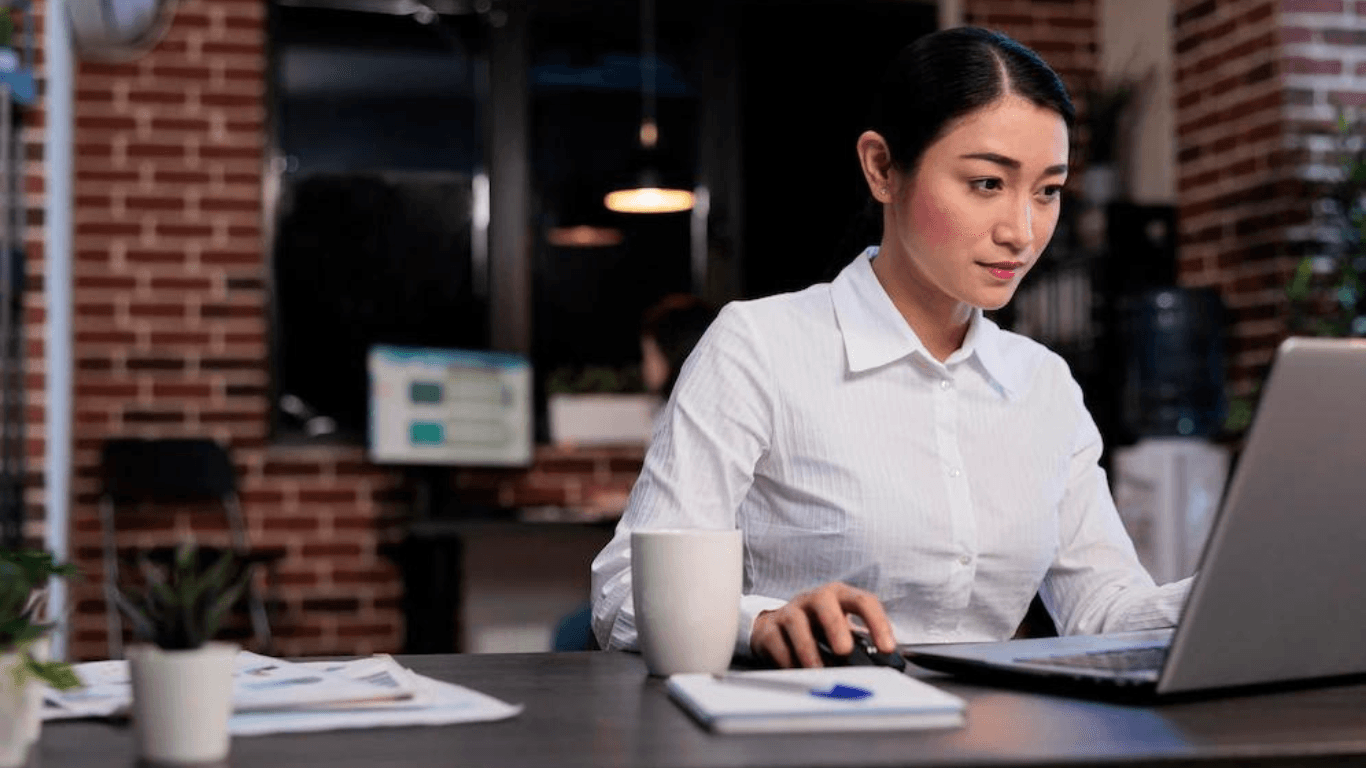 A product data expert working in front of her laptop