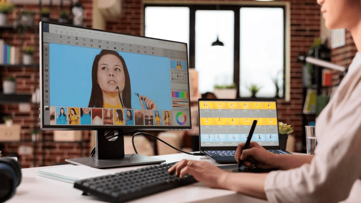 A graphic designer editing a photo with a retouching tool