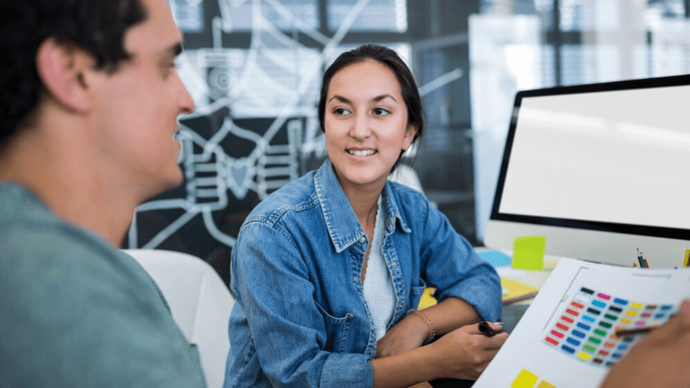 A female and male web designer talking about a project