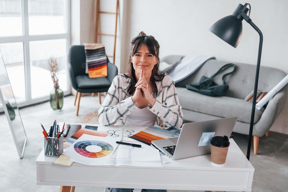 A female graphic designer working indoors in front of her laptop