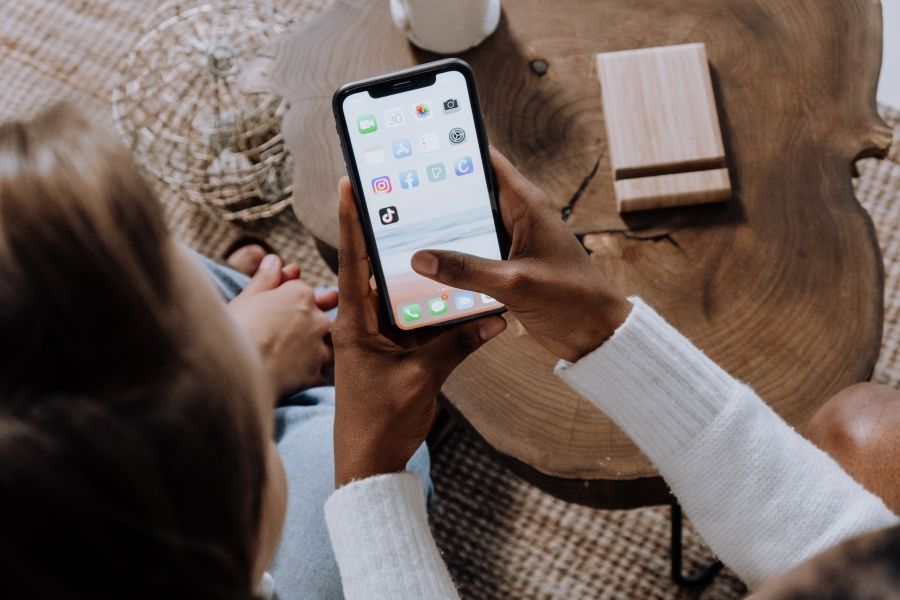 people-looking-at-a-phone-screen-with-various-social-media-apps.jpg