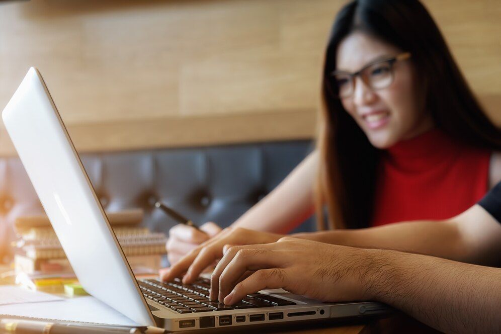 A product content writer typing on his laptop keyword