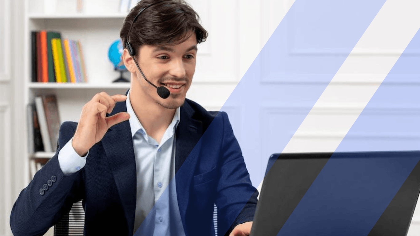 A male customer service agent talking over a laptop